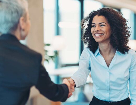 Smiling businesswoman greeting a colleague on a meeting female financial professional