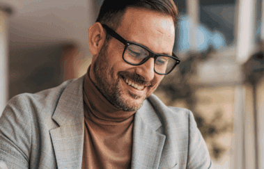 Confident financial advisor reviewing documents and smiling, representing successful securities and insurance cross-sell strategy