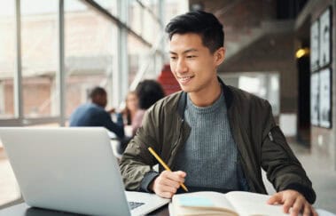Student preparing online to improve SIE Exam pass rate with study materials and notes.