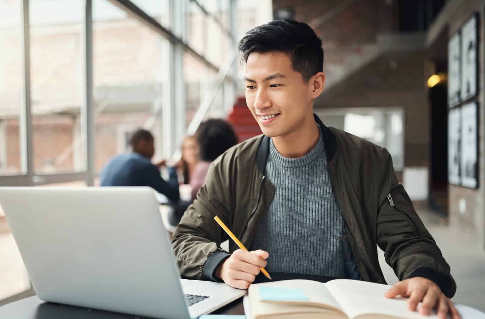 Student preparing online to improve SIE Exam pass rate with study materials and notes.