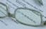 Close-up of glasses highlighting the One Big Beautiful Bill document, representing major tax changes for securities professionals