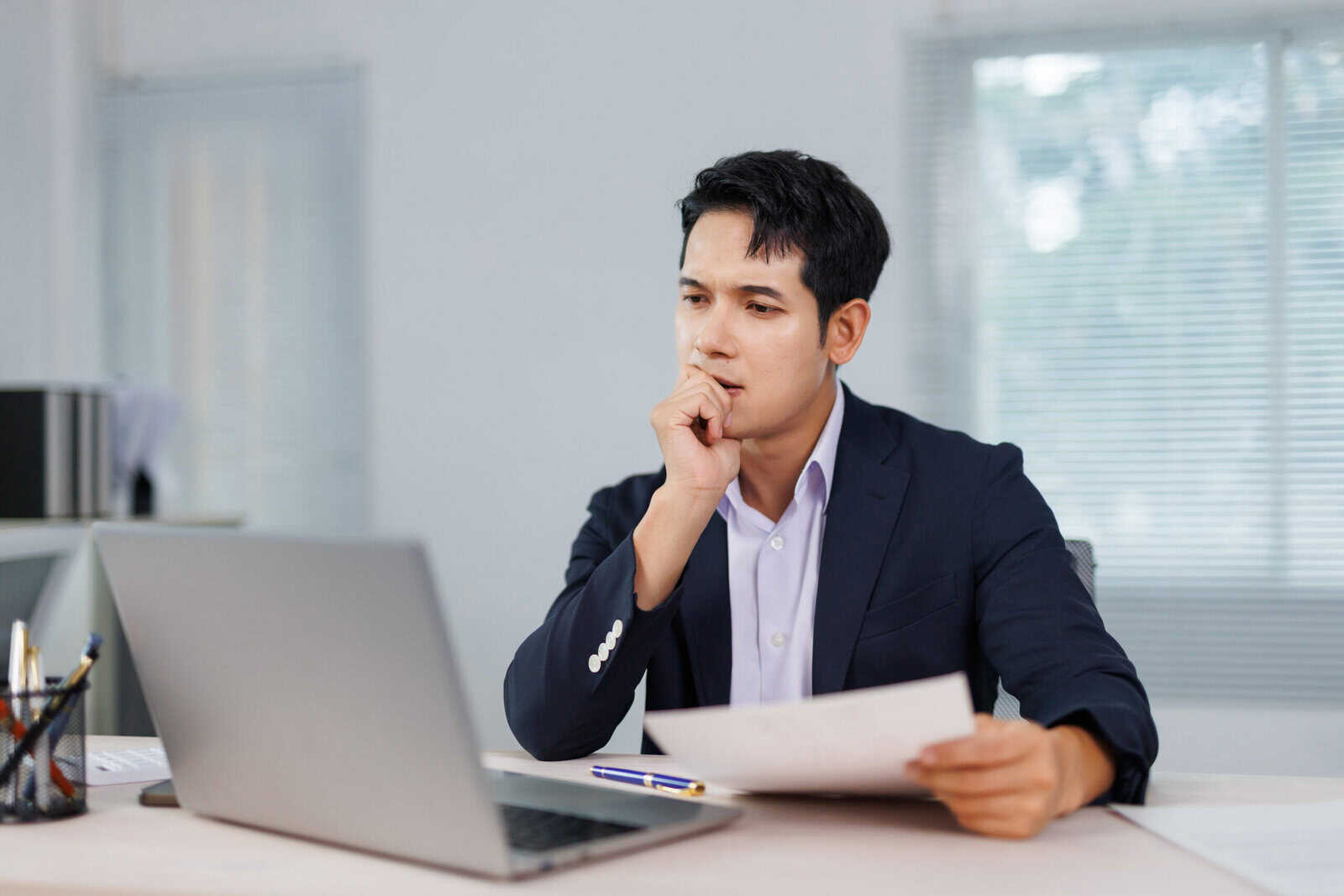 Investment adviser reviewing documents on a laptop after missing the IAR CE deadline